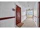 Hallway entrance to condo #E230, featuring carpet flooring and a bright window at the end of the corridor at 1100 Possum Trot Rd. # E-238, North Myrtle Beach, SC 29582