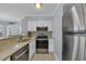 Modern kitchen with stainless steel appliances and a tile backsplash at 1100 Possum Trot Rd. # E-238, North Myrtle Beach, SC 29582