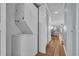 Efficient laundry area with stacked washer and dryer, leading to a living space at 1100 Possum Trot Rd. # E-238, North Myrtle Beach, SC 29582
