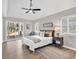 Bright bedroom with neutral colors, wood floors, ceiling fan, and sliding glass door to the backyard at 1165 Carnoustie Ct., Myrtle Beach, SC 29575