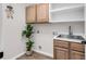 Convenient laundry room with sink, cabinets, and modern finishes at 1165 Carnoustie Ct., Myrtle Beach, SC 29575