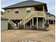 Elevated cottage-style home with stairs and deck at 121 Marshland Ct., Myrtle Beach, SC 29572