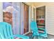 Private balcony with two teal chairs and sliding door access at 1302 River Oaks Dr. # 4-F, Myrtle Beach, SC 29579