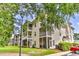 Three-story building with screened porches and lush landscaping at 1302 River Oaks Dr. # 4-F, Myrtle Beach, SC 29579