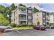 Two-story condo building with ample parking and landscaping at 1302 River Oaks Dr. # 4-F, Myrtle Beach, SC 29579