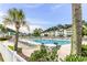 Community pool with lounge chairs and palm trees at 1302 River Oaks Dr. # 4-F, Myrtle Beach, SC 29579