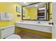 Bathroom with single sink vanity and yellow walls at 1501 Ocean Blvd. # 945, Myrtle Beach, SC 29577