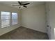 Bright bedroom with carpet flooring, ceiling fan, and two windows at 155 Crabapple Dr., Longs, SC 29568