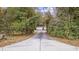 Long driveway leading to a house nestled among lush greenery at 1647 Running Water Dr., Murrells Inlet, SC 29576