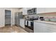 Modern kitchen with stainless steel appliances, stone counters and white cabinets at 181 Ashworth Dr., Tabor City, NC 28463