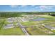 New construction community with pristine landscaping, lush trees, and a tranquil pond at 201 Ashworth Dr., Tabor City, NC 28463