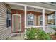 Inviting front porch with brick accents and landscaping at 203 Knight Circle # 2, Pawleys Island, SC 29585