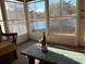 Sunroom overlooking a pond with a wooden coffee table at 203 Knight Circle # 2, Pawleys Island, SC 29585