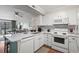 White kitchen with quartz countertops and stainless steel appliances at 207 N Ocean Blvd. # 146, North Myrtle Beach, SC 29582