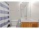 Bathroom with shower/tub, wood vanity, and striped curtain at 2209 Beauclair Ct., Myrtle Beach, SC 29579