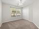 Spacious bedroom with large window, carpet, and double doors at 2209 Beauclair Ct., Myrtle Beach, SC 29579