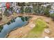 Aerial view of the condo community showcasing the golf course and pond at 242 Sun Colony Blvd. # 303, Longs, SC 29568