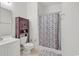 Bathroom featuring a shower with a patterned curtain, toilet, and rustic vanity at 242 Sun Colony Blvd. # 303, Longs, SC 29568