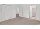 Bedroom featuring neutral carpet, ample closet space, and a view into another room at 242 Sun Colony Blvd. # 303, Longs, SC 29568