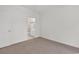 Neutral bedroom featuring plush carpet, a door, and a view into a bathroom at 242 Sun Colony Blvd. # 303, Longs, SC 29568