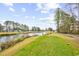 Scenic view of the golf course and pond, surrounded by lush greenery and the condo community at 242 Sun Colony Blvd. # 303, Longs, SC 29568