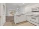 Bright kitchen featuring white cabinetry, appliances, and a convenient layout at 242 Sun Colony Blvd. # 303, Longs, SC 29568