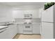Clean, white kitchen with efficient appliances and ample storage at 242 Sun Colony Blvd. # 303, Longs, SC 29568