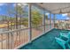 Screened porch featuring seating with views of the lake, surrounding landscaping, and nearby homes at 242 Sun Colony Blvd. # 303, Longs, SC 29568