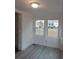 Living room with grey vinyl flooring and two windows at 326 East Godbold St., Marion, SC 29571