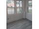 Sunroom with grey vinyl flooring and multiple windows at 326 East Godbold St., Marion, SC 29571