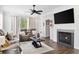 Living area with fireplace, large TV, and hardwood floors at 326 Winding Brook Ct., Murrells Inlet, SC 29576