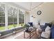 Relaxing sunroom with ample natural light and comfy seating at 326 Winding Brook Ct., Murrells Inlet, SC 29576