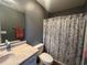Bathroom with a sink, mirror, toilet, and shower with a patterned curtain at 389 Cabo Loop, Myrtle Beach, SC 29588