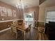 Cozy dining room featuring decorative wall art, chandelier lighting, and easy access to the backyard at 389 Cabo Loop, Myrtle Beach, SC 29588