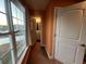 Hallway with a view of a bathroom and exterior, featuring a door, window and sunset at 389 Cabo Loop, Myrtle Beach, SC 29588