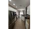Galley kitchen featuring stainless steel appliances, granite countertops, and ample white cabinet storage at 389 Cabo Loop, Myrtle Beach, SC 29588