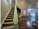 Open-concept living room with staircase, hardwood floors, and easy access to the dining room at 389 Cabo Loop, Myrtle Beach, SC 29588