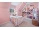 Cozy pink bedroom with charming details, a window, shelving, and a cute, colorful quilt at 40 Capt Anthony White Ln., Georgetown, SC 29440
