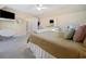Bright, carpeted bedroom featuring a TV, white furniture and décor, and a comfortable round papasan chair at 40 Capt Anthony White Ln., Georgetown, SC 29440
