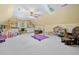 Spacious playroom featuring bright yellow walls, skylights, built in shelves, a desk, and padded gymnastics equipment at 40 Capt Anthony White Ln., Georgetown, SC 29440