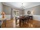 Formal dining room with wood floors, elegant chandelier, and large window at 40 Capt Anthony White Ln., Georgetown, SC 29440