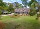 Charming home with a landscaped front yard and covered porch, surrounded by mature trees at 40 Capt Anthony White Ln., Georgetown, SC 29440