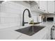 Close-up view of kitchen sink with black faucet and white tile backsplash at 40 Capt Anthony White Ln., Georgetown, SC 29440