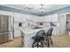 Bright kitchen features white cabinets, granite countertops, and a stylish center island with seating at 40 Capt Anthony White Ln., Georgetown, SC 29440