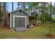 Outdoor shed with ramp and covered patio, plus a grill and seating area for relaxing in the backyard at 40 Capt Anthony White Ln., Georgetown, SC 29440