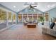 Bright sunroom with tile flooring, wicker furniture, and natural light at 40 Capt Anthony White Ln., Georgetown, SC 29440