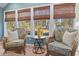 Cozy sunroom with large windows and comfortable wicker seating at 40 Capt Anthony White Ln., Georgetown, SC 29440