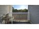 Small balcony with table and chairs, offering a wooded view at 401 N Hillside Dr. # 3C, North Myrtle Beach, SC 29582
