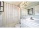 Clean bathroom with white vanity and striped shower curtain at 401 N Hillside Dr. # 3C, North Myrtle Beach, SC 29582