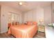Bright bedroom with orange bedding and mirrored closet doors at 401 N Hillside Dr. # 3C, North Myrtle Beach, SC 29582